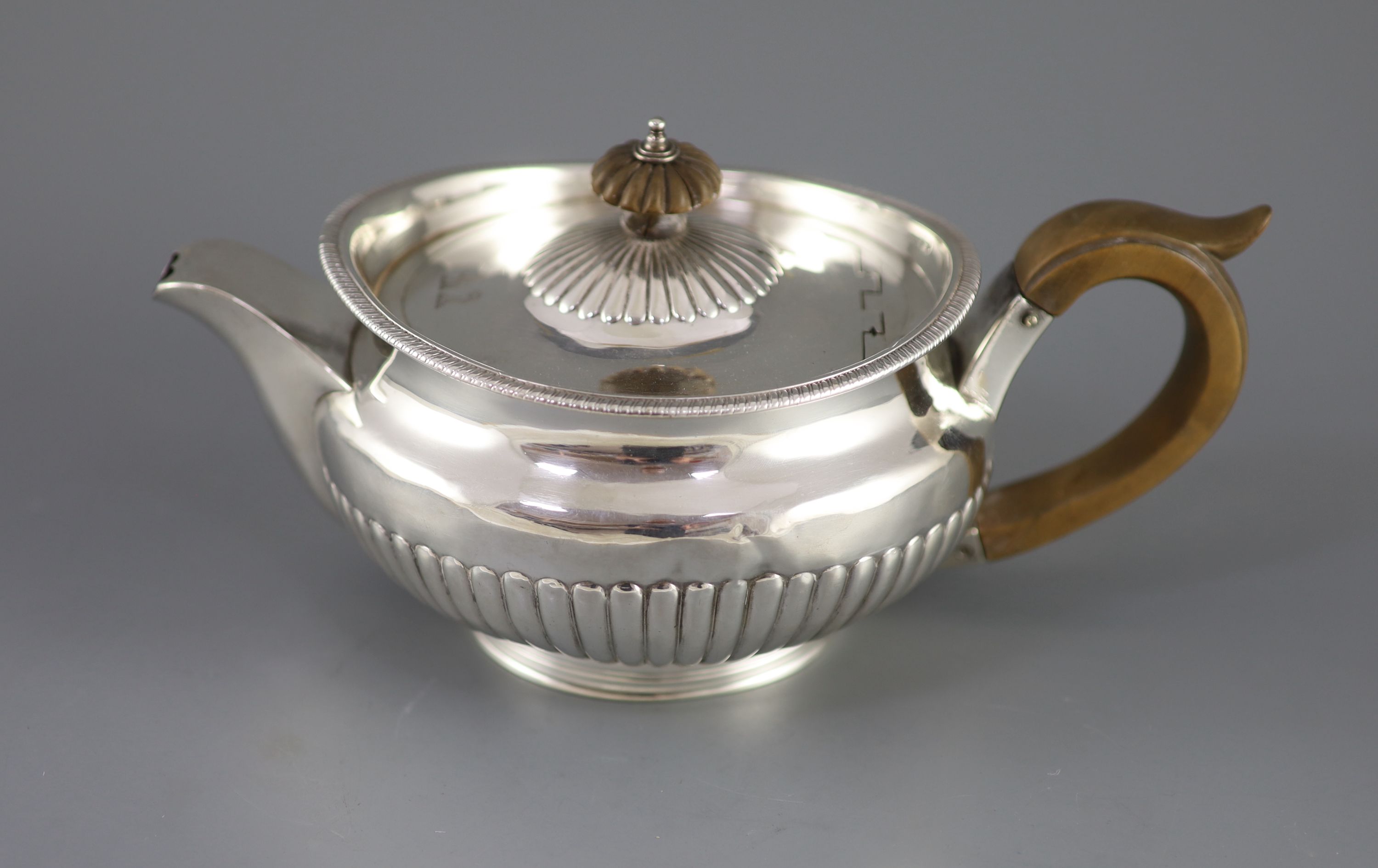 A George III demi-fluted silver squat circular teapot, by Robert & Samuel Hennell